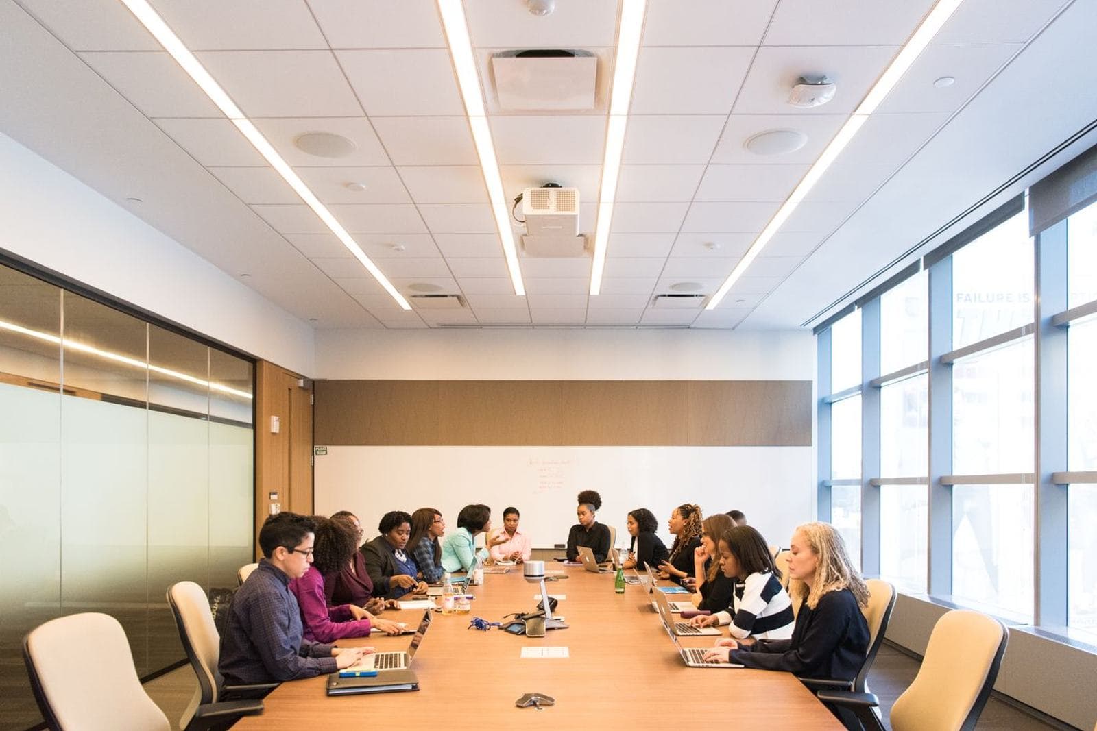 Students or professionals in a meeting, presenting, or shaking hands
