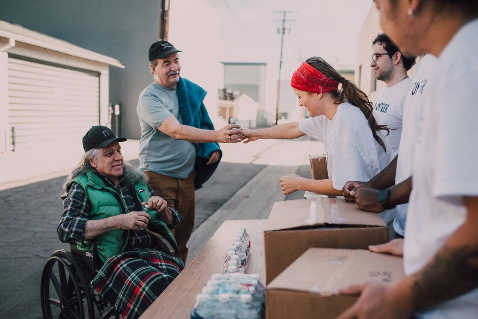 Volunteers handing out supplies or donations from a table